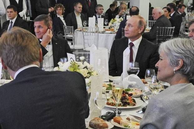 Michael Flynn (left) and Vladimir Putin (right). Former Green Party presidential candidate Jill Stein can also be spotted in the lower right-hand corner. (Michael Klimentyev/Sputnik via Associated Press))