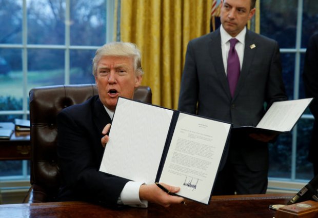President Trump showing off the executive order to withdraw the United States from the Trans Pacific Partnership. (Reuters/Kevin Lamarque)